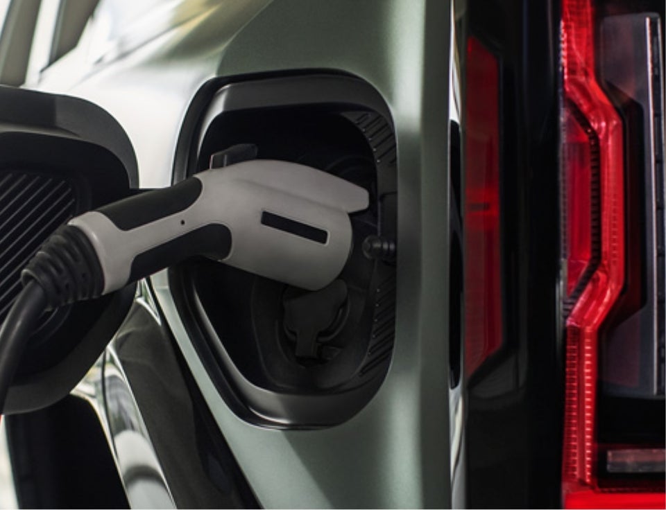 Close up of charging port with charger plugged in on a GMC Hummer EV SUV - Hittle GMC in GREENVILLE OH